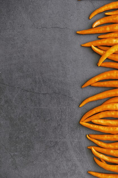 Hot orange pepper. Chilean pepper on a black background.