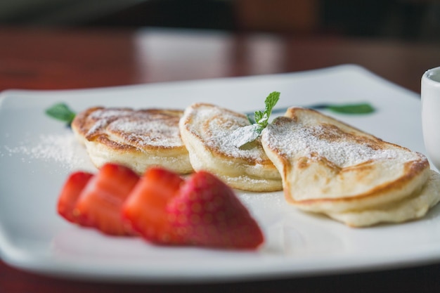 Hot pancake with strawberry and sauce - fritters of cottage cheese, taste breakfast, macro, close up