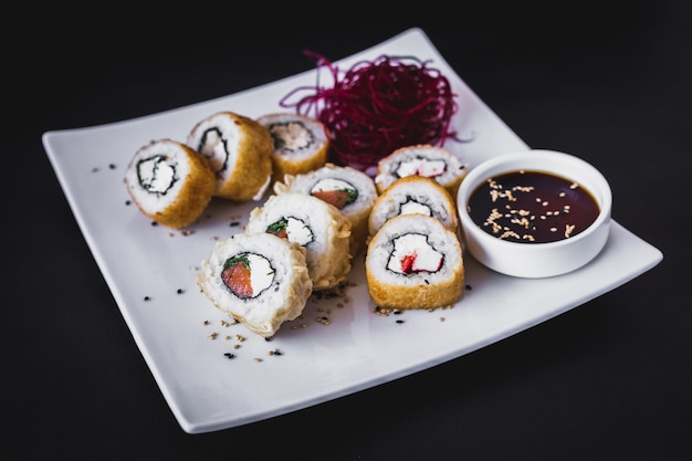 Hot panko sushi roll with soy sauce and sesame