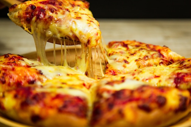 Hot pizza slice with melting cheese.