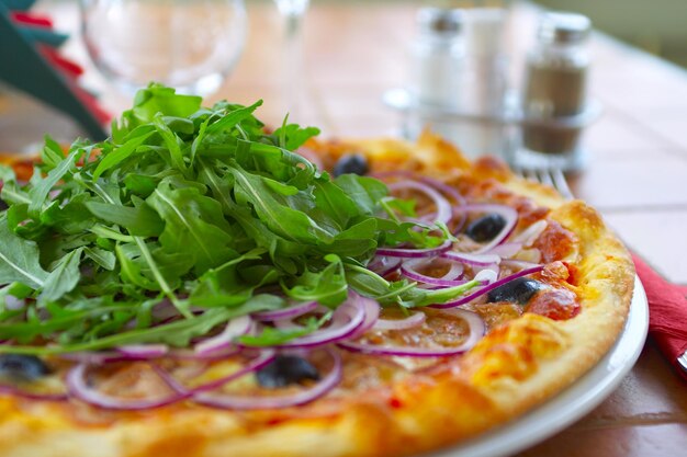 Hot pizza on a table in cafe