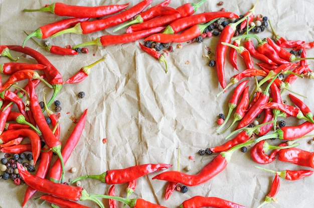 Hot red chili pepper on vintage paper background