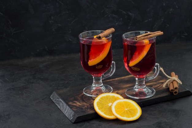 hot red drink in transparent circles with cinnamon and orange 