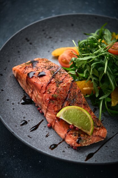 Hot smoked salmon with arugula salad, cherry tomato, and orange