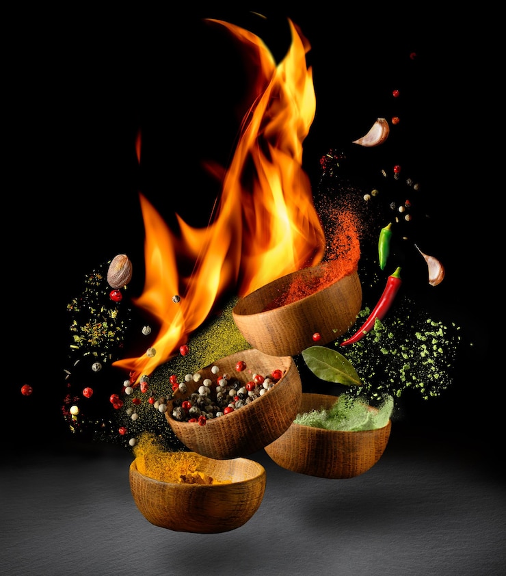 Photo hot spices and seasonings powder splash explosion on black background with flame