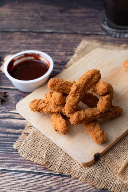 Hot and spicy Korean barbeque fried chicken on wood cutting board