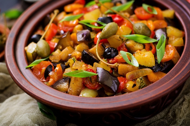 Hot spicy stew (caponata) eggplant, zucchini, sweet pepper, tomato, carrot, onion, olives and capers