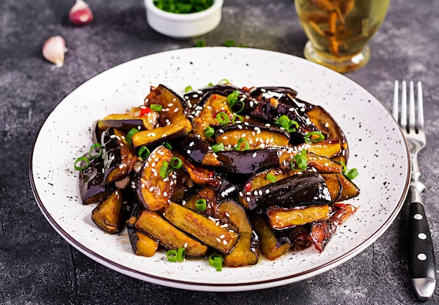 Photo hot spicy stew eggplant in korean style with green onion. aubergine saute.