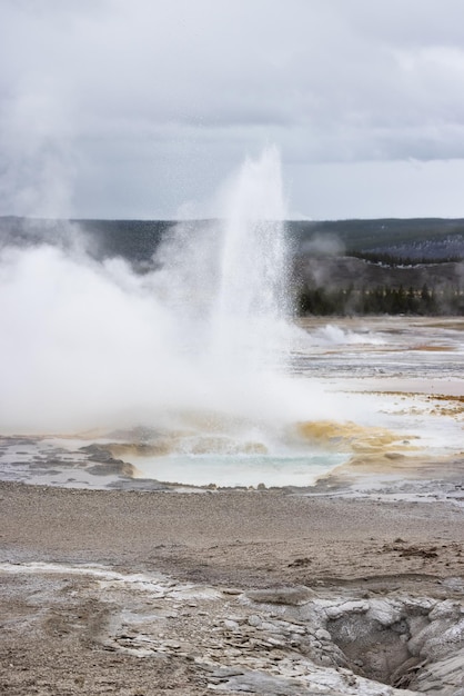 Hot spring geyser with colorful water in american landscape