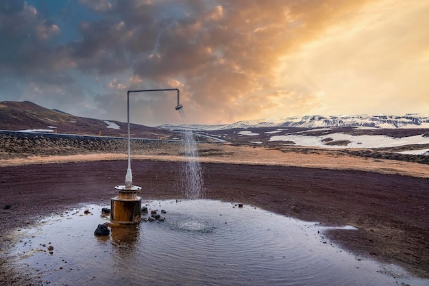 Hot spring shower from geothermal power at krafla against mountain