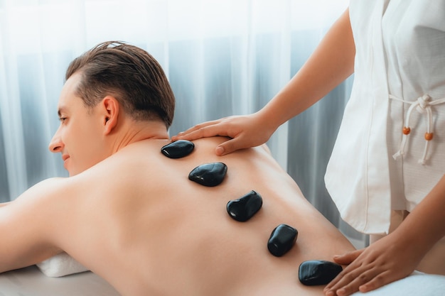 Hot stone massage at spa salon in luxury resort Quiescent