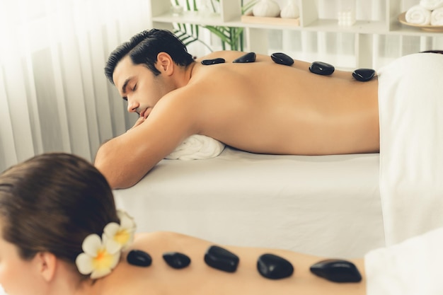 Hot stone massage at spa salon in luxury resort quiescent