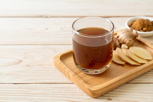 hot and sweet ginger juice glass with ginger roots - Healthy drink style