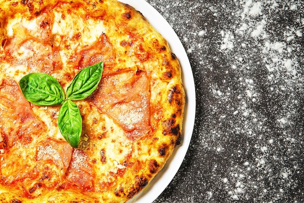 Hot tasty traditional italian pizza with ham