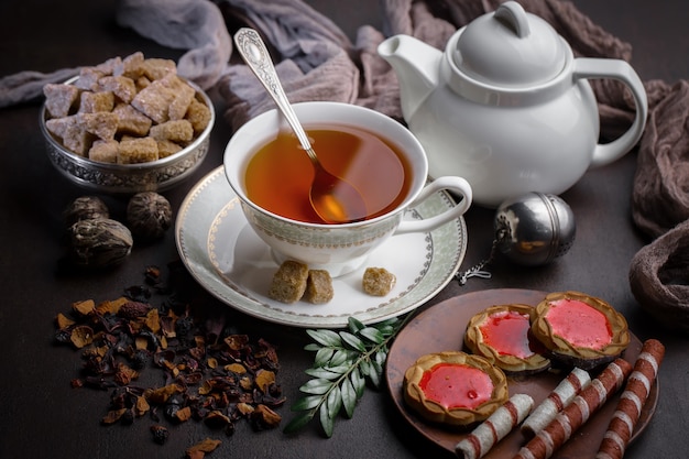 Hot tea in a cup on an old background