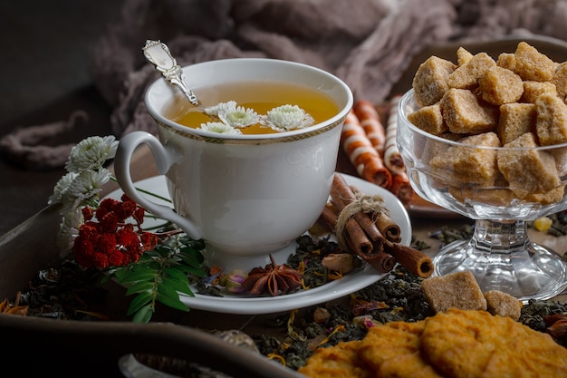 Hot tea in a cup on an old background