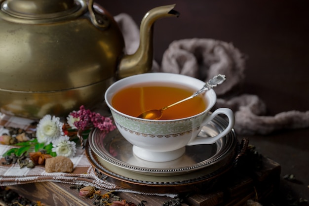 Hot tea in a cup on an old background