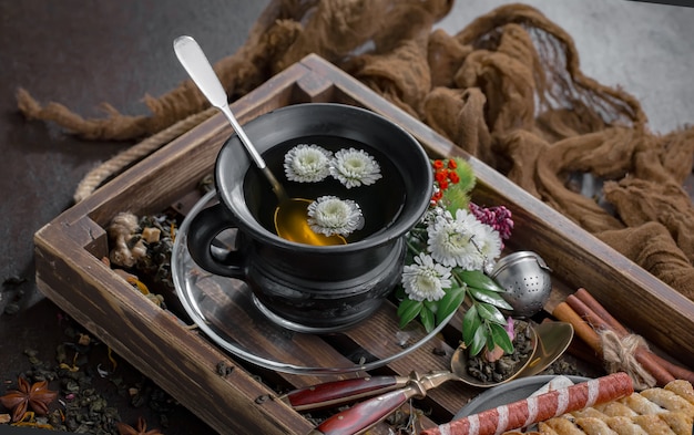 Hot tea in a cup on an old background