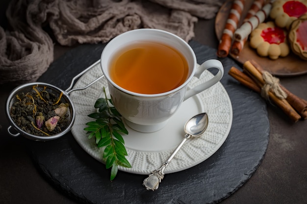 Hot tea in a cup on an old background.