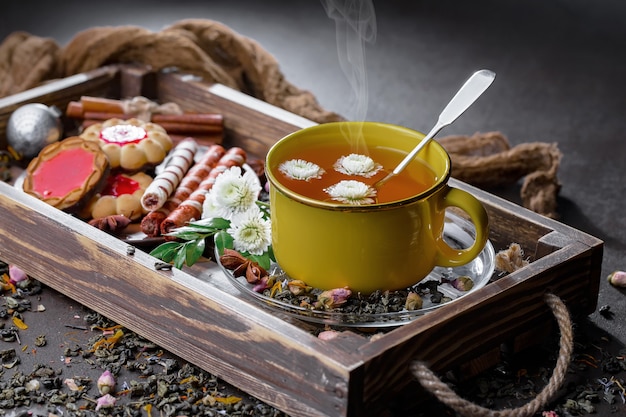 Hot tea in a cup on an old background