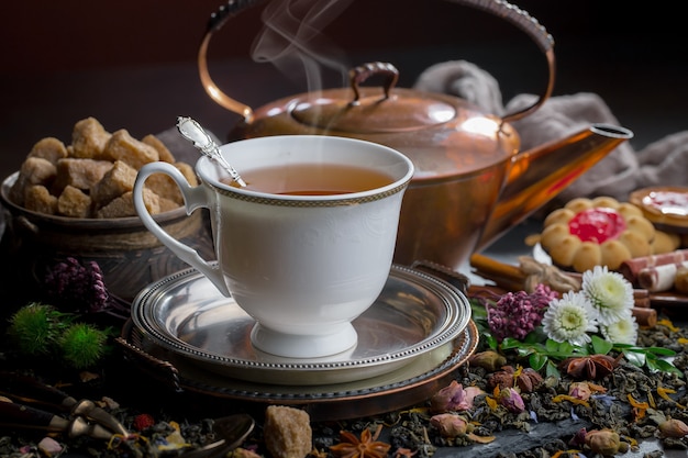 Hot tea in a cup on an old background