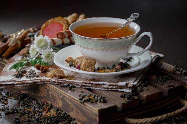 Hot tea in a cup on an old background