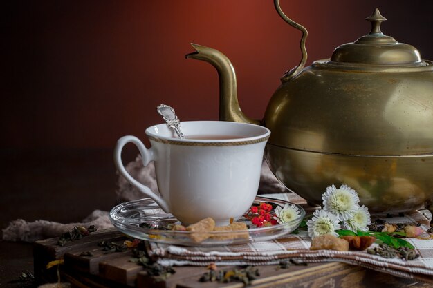 Hot tea in a cup on an old background