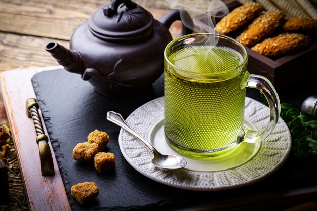 Hot tea in a cup on an old table.