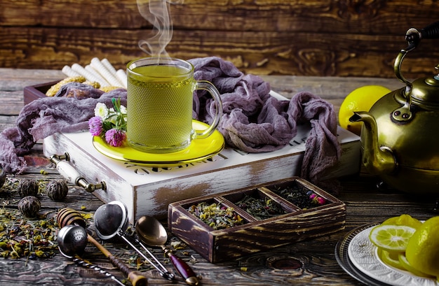 Hot tea in a cup on an old table.