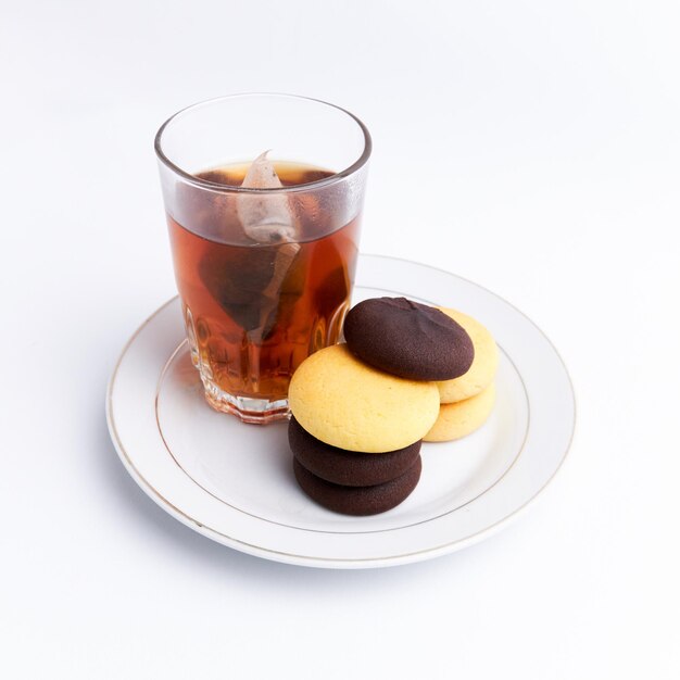 Hot tea and delicious brownies ready to eat on a white background