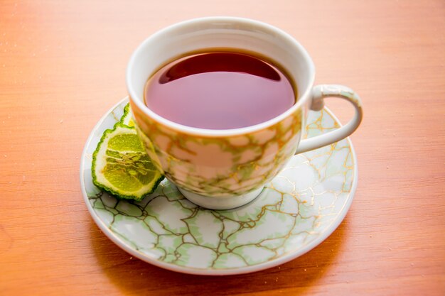 Hot tea with bergamot on wooden table in the cold. Winter.