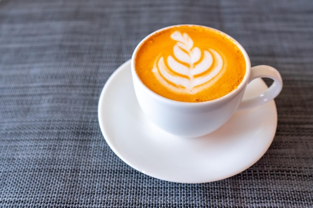 Hot tea with latte art in white coffee cup