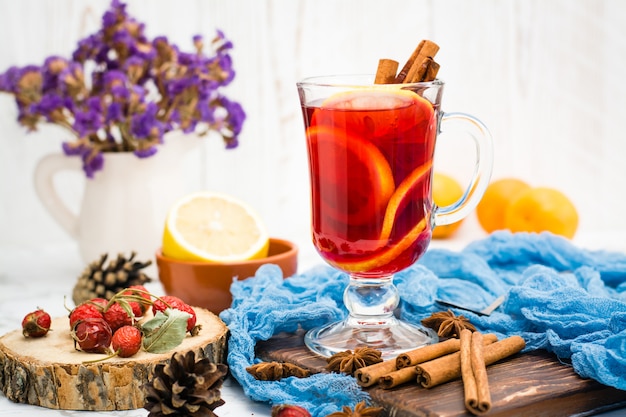 Hot tea with lemon and cinnamon in a glass