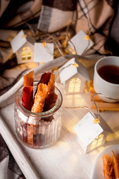 Hot Tea with lemon in cup with dry fruits pastille