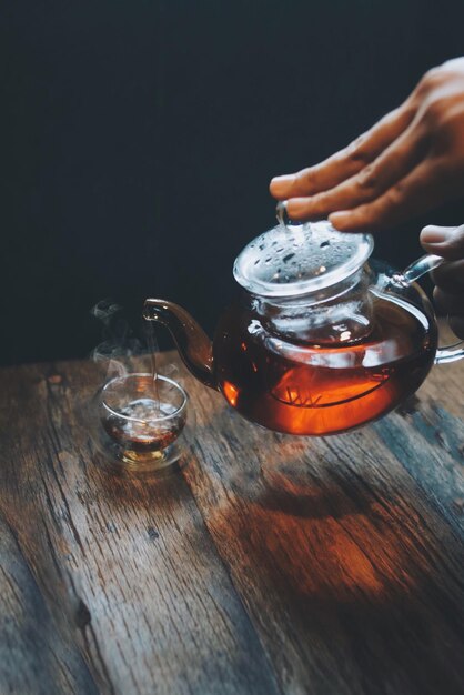 Hot teapot and cups on wooden table