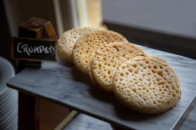 Hot toasted english crumpets arranged in a line