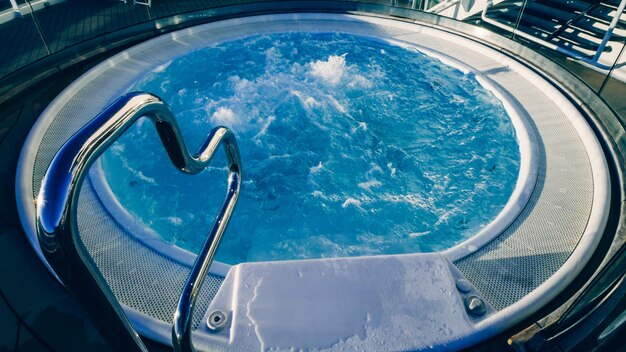 A hot tub with a metal hand rail