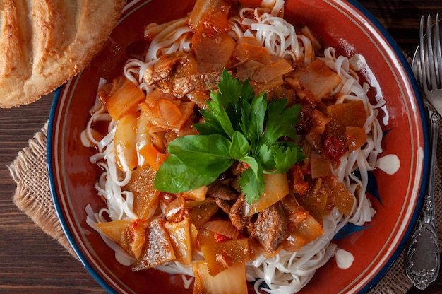 Hot Uighur dish served with herbs and flatbread