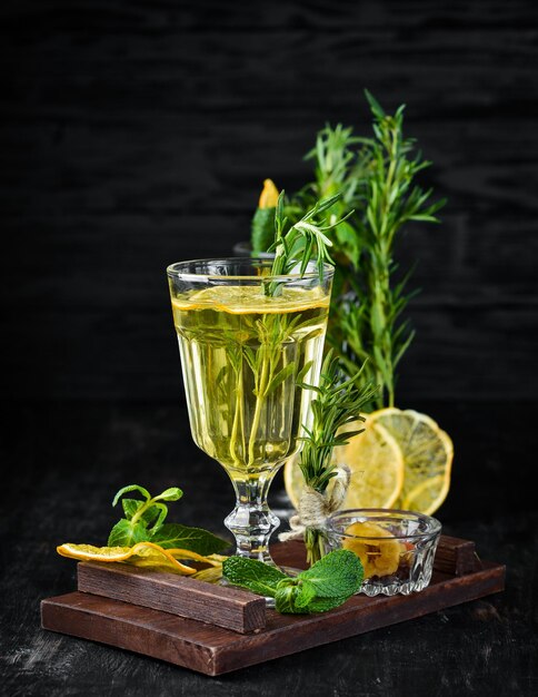 Hot white wine and rosemary cocktail On a wooden background Top view Free copy space