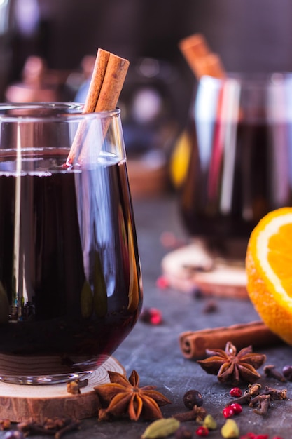 Hot wine with spices in glass glasses Mulled wine with cinnamon and star anise on a blue table