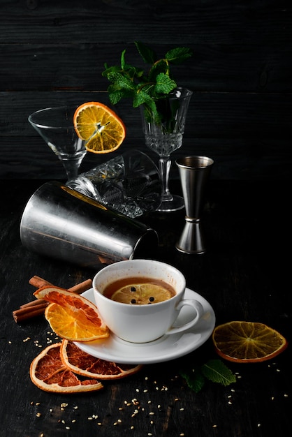 Hot winter cocktail Tea with rum and lemon and cinnamon On a wooden background Top view Free copy space