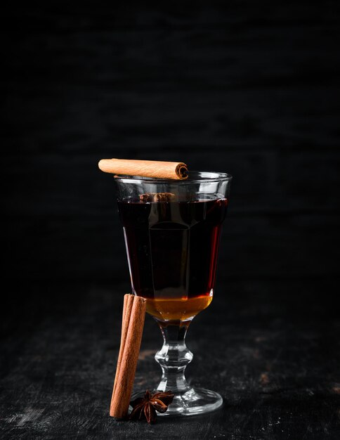 Hot winter wine cocktail On a wooden background Top view Free copy space