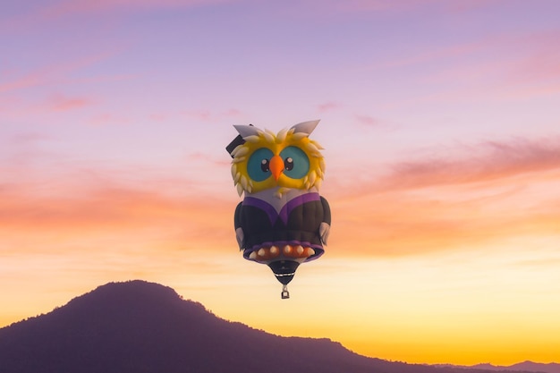 カラフルな日の出の空を背景にさまざまな色の熱気球