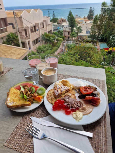 Premium Photo | Hotel breakfast on table with ocean view