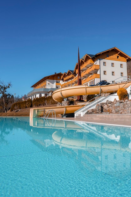 Hotel buildings reflection on calm water of swimming pool