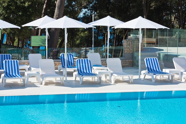 Hotel Poolside Chairs with Sea view. Summer shot