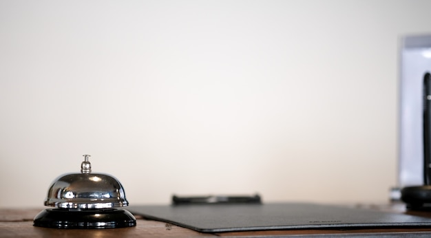 Hotel reception counter desk with service bell.