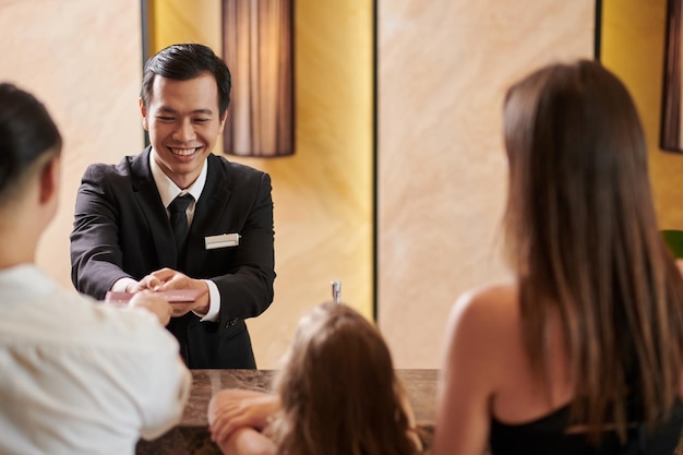 Hotel Receptionist Talking to Guests