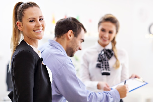 hotel receptionist talking with guests