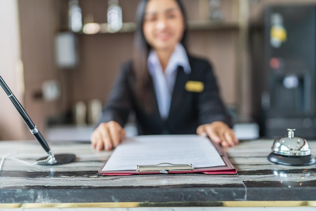 Hotel receptionist in uniforms at desk in lobby Friendly and welcome staff in hotel reception counter